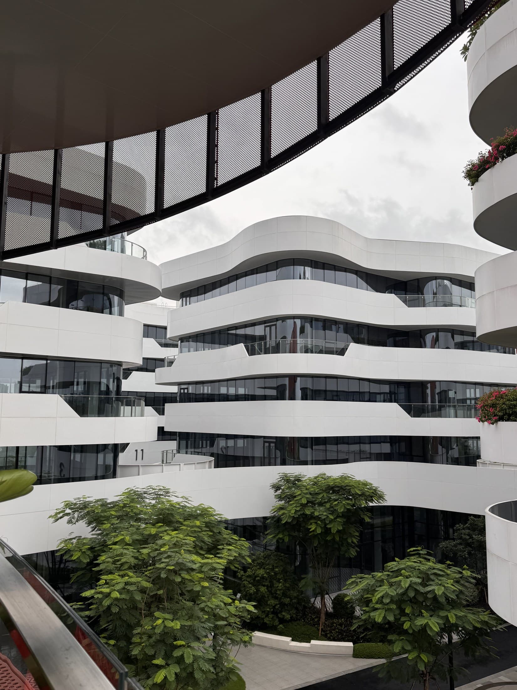 Courtyard framed by the curved white architecture of Shiwan MAX Technology Park